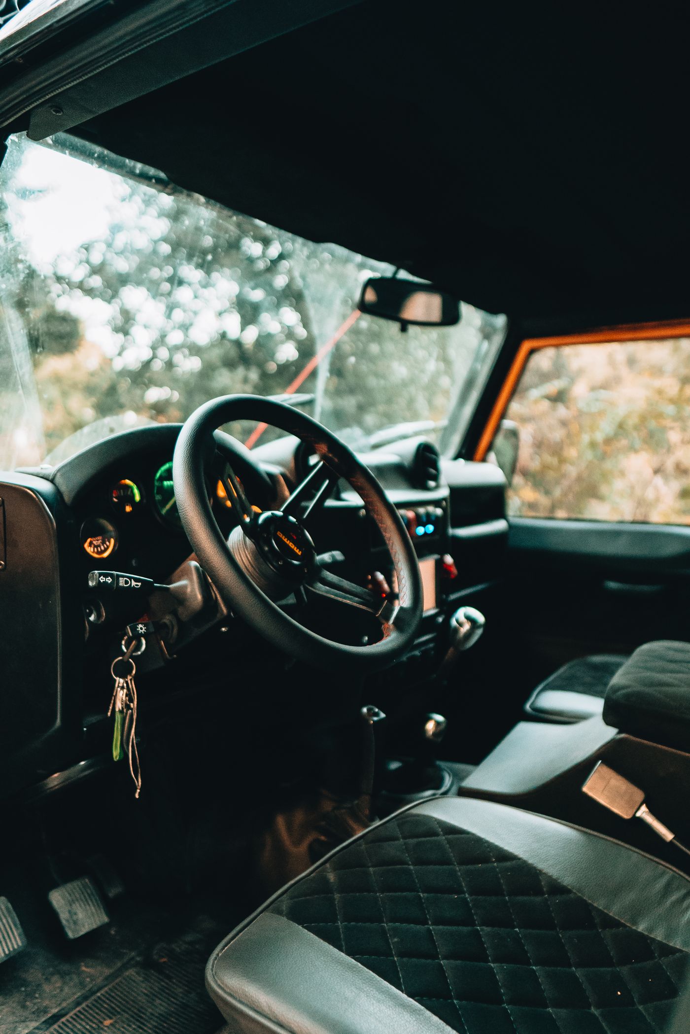 Quilted leather seats and refined controls inside a luxury car cabin.